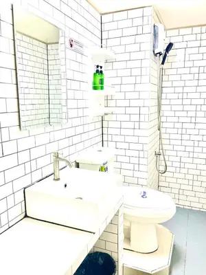 a white bathroom with a sink and a toilet at Impact Arena Condo C3 by GoodRoom24 in Ban Bang Phang