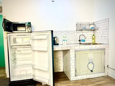 a kitchen with an open refrigerator and a sink at Impact Arena Condo C3 by GoodRoom24 in Ban Bang Phang