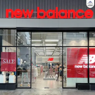 a new balance store with people walking inside of it at Impact Arena Condo C9 by GoodRoom24 in Pak Kret