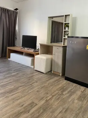 an office with a desk with a computer and a refrigerator at Impact Arena Condo C9 by GoodRoom24 in Pak Kret