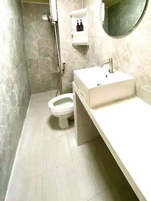 a bathroom with a sink and a toilet at Impact Arena Condo The Classic by GoodRoom24 in Ban Song Hong