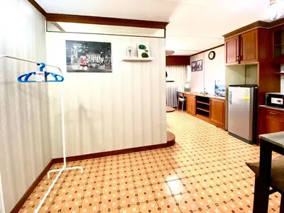 a kitchen with a glass door to a kitchen with a refrigerator at Impact Arena Condo The Classic by GoodRoom24 in Ban Song Hong