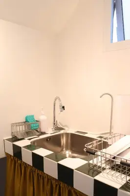 a kitchen with a sink and two faucets at House 33 in Bangkok
