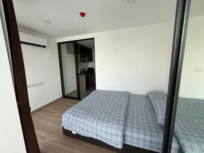 a bedroom with a bed and a mirror at Cybiq Ratchada 32 By OBM in Ban Zong Katiam