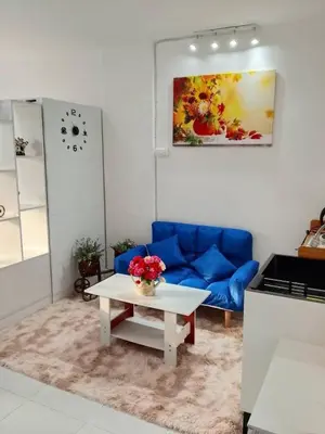 a living room with a blue couch and a table at City villa condo - Cozy budget flat in LadPhao rd, Bangkapi in Ban Bang Toei (1)