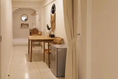 a kitchen and dining room with a table and a table and chairs at baan nuit Bangkok Stayhouse in Bangkok