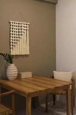 a wooden table in a living room with a dining room table at baan nuit Bangkok Stayhouse in Bangkok