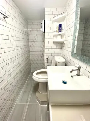 a white bathroom with a toilet and a sink at Impact Arena C3 Twin Beds By GoodRoom 24 in Ban Bang Phang