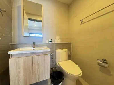 a bathroom with a toilet and a sink at Neon Cloud Bangkok in Bangkok