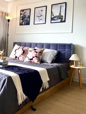 a bedroom with a blue bed with pillows on it at Impact Arena C75fl by GoodRoom24 in Ban Song Hong