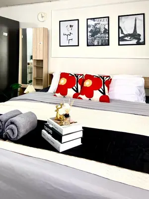 a bedroom with a large bed with red pillows at Impact Arena Condo C7 fl12 By GoodRoom24 in Ban Song Hong