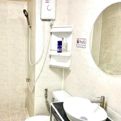 a bathroom with a sink and a mirror and a toilet at Impact Arena Condo C7 fl12 By GoodRoom24 in Ban Song Hong