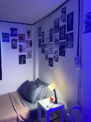 a bedroom with a bed and a table with a lamp at Best Stay 394 homestay in Phra Khanong