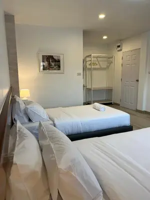a bedroom with two beds and a closet at Silpasala StayZ in Sathani Ban Hua Mak