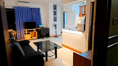 a living room with a couch and a table at River View Bangkok in Bangkok