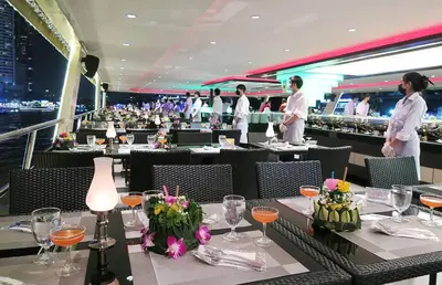 a restaurant with tables with people standing in the background at River View Bangkok in Bangkok