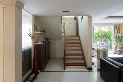 a room with a staircase leading to a living room at Modern Home in Sukhumvit in Bangkok