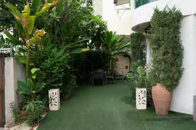a garden with plants and a table and chairs at Modern Home in Sukhumvit in Bangkok