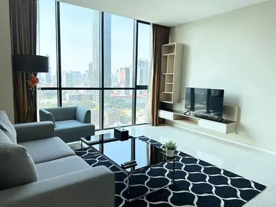 a living room with a couch and a tv at Spacious Serviced Apartment! in Bangkok