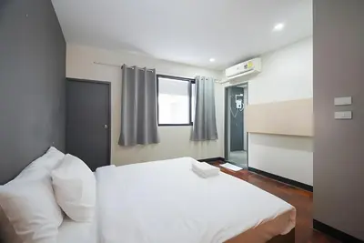 a bedroom with a white bed and a window at XX GO INN BTS Silom - Saint Louis สถานีรถไฟฟ้าเซนต์หลุยส์ in Bangkok