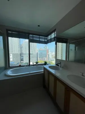a large bathroom with two sinks and a large window at The Emporio Place in Bangkok
