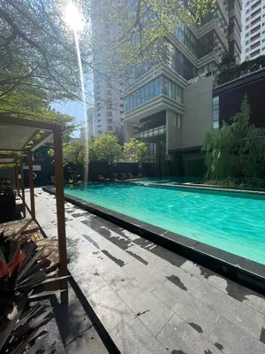 a swimming pool in front of a building at The Emporio Place in Bangkok