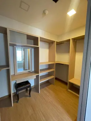 an empty room with a desk and a mirror at The Emporio Place in Bangkok