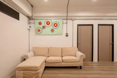 a living room with a couch and a painting on the wall at Silom Condominium in Bang Rak