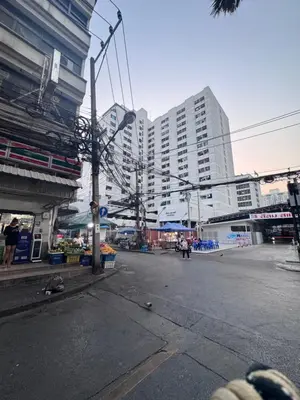 an empty street in a city with tall buildings at Silom Condominium in Bang Rak