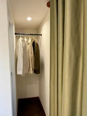a closet with a curtain next to a door at D Glamor Hotel Phutthamonthon Sai 1 ,Southern Bus Terminal, Bangkok in Bangkok
