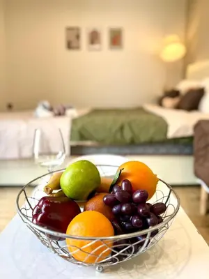 a bowl of fruit sitting on a table at D Glamor Hotel Phutthamonthon Sai 1 ,Southern Bus Terminal, Bangkok in Bangkok