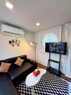a living room with a couch and a flat screen tv at D Glamor Hotel Phutthamonthon Sai 1 ,Southern Bus Terminal, Bangkok in Bangkok