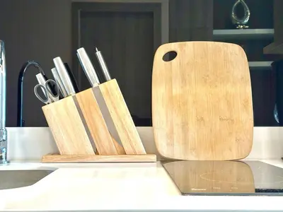 a wooden cutting board sitting on top of a counter at Cozy & Bright apartment - Asoke in Bangkok