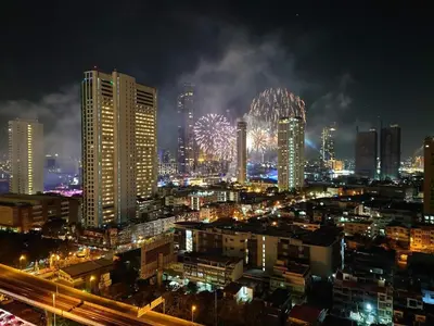 a city lit up at night with fireworks at 1 Bedroom Condo Pool Gym BTS Cowork Sky in Godown