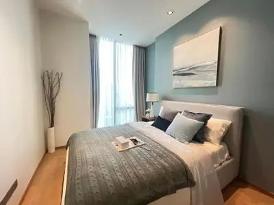 a bedroom with a large bed with a tray on it at Luxury Apartment Best Location Silom in Bangkok