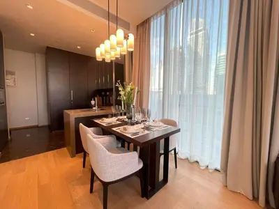 a dining room with a table with chairs and a large window at Luxury Apartment Best Location Silom in Bangkok