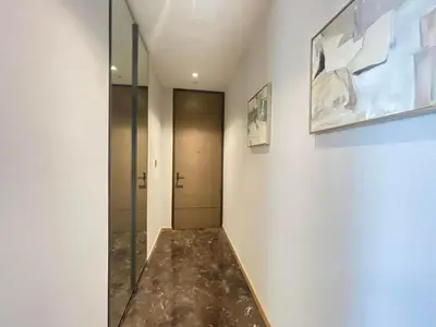 a hallway with a walk in shower and a glass door at Luxury Apartment Best Location Silom in Bangkok