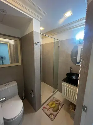 a bathroom with a shower and a toilet and a sink at Euro Classic Condominium in Bangkok