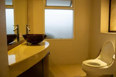 a bathroom with a bowl sink and a toilet at Luxury 4 KingSize BedRooms - Central & Modern Sukhumvit in Bangkok