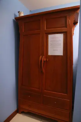a wooden cabinet with a sign on top of it at UPAR Hotels Silom in Bangkok