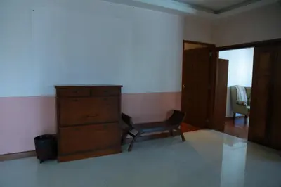 a bedroom with a dresser and a chair in a room at UPAR Hotels Silom in Bangkok