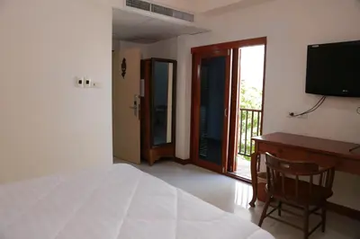 a bedroom with a bed and a desk and a television at UPAR Hotels Silom in Bangkok