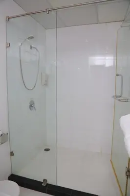 a shower with a glass door in a bathroom at UPAR Hotels Silom in Bangkok