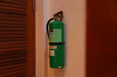 a green fire hydrant hanging on a wall at UPAR Hotels Silom in Bangkok