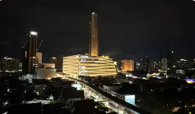 a city skyline at night with a tall building at Free Airport Pick Up ! 12th Floor Cozy Studio Room, 5 mins walk to IconSiam & BTS in Bangkok