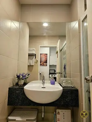 a bathroom with a white sink and a mirror at Free Airport Pick Up ! 12th Floor Cozy Studio Room, 5 mins walk to IconSiam & BTS in Bangkok
