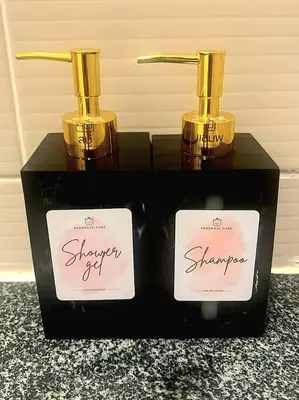 two bottles of shower gel sitting on a black box at Free Airport Pick Up ! 12th Floor Cozy Studio Room, 5 mins walk to IconSiam & BTS in Bangkok
