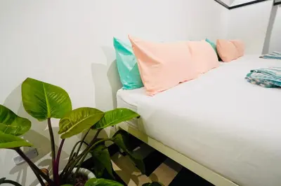 a room with a bed and a plant at The Local Khaosan Bangkok Hotel in Bangkok