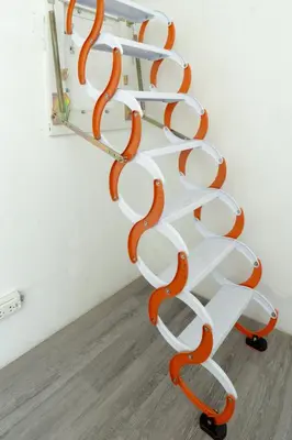 a white and orange spiral staircase in a room at The Local Khaosan Bangkok Hotel in Bangkok