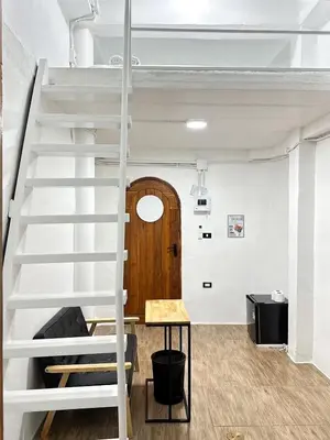 a loft bed in a room with a staircase at Megun Room5 in Ban Bang Phlat